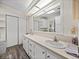 Bright bathroom features double sinks, plentiful counter space, and modern wood-look flooring at 1823 Sherwood Hill Dr, Lakeland, FL 33810