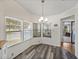 Dining area with modern gray wood flooring and bright natural lighting at 1823 Sherwood Hill Dr, Lakeland, FL 33810