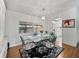 Dining area with glass table, decorative rug, and view into the kitchen at 1823 Sherwood Hill Dr, Lakeland, FL 33810