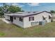 Charming single-story home with a durable metal roof, featuring well-maintained exterior and lush greenery at 1823 Sherwood Hill Dr, Lakeland, FL 33810