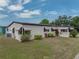 Well-maintained home featuring charming exterior with a lush, landscaped yard and vibrant flowering bushes at 1823 Sherwood Hill Dr, Lakeland, FL 33810