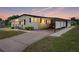 Charming single-story home with a covered parking area and well-maintained landscaping under a beautiful sunset at 1823 Sherwood Hill Dr, Lakeland, FL 33810