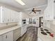 Efficient kitchen with bright white cabinets, plenty of counter space, modern appliances, and wood-look vinyl flooring at 1823 Sherwood Hill Dr, Lakeland, FL 33810
