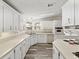 Bright kitchen featuring white cabinets, modern appliances, ample counter space, and wood-look vinyl flooring at 1823 Sherwood Hill Dr, Lakeland, FL 33810