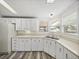 Bright kitchen with white cabinets, modern flooring, and natural light from the bay window at 1823 Sherwood Hill Dr, Lakeland, FL 33810