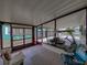 Screened lanai providing a relaxing outdoor space with comfortable seating and a golf cart parked inside at 1823 Sherwood Hill Dr, Lakeland, FL 33810