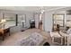 Cozy sunroom featuring neutral carpet, wood paneled walls, and large windows at 1823 Sherwood Hill Dr, Lakeland, FL 33810
