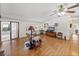 Cozy living room with natural light, hardwood floors, a comfortable recliner, and access to a screened lanai at 1823 Sherwood Hill Dr, Lakeland, FL 33810