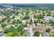 Aerial view of a neighborhood showcasing the house, mature trees, and proximity to a golf course under a sunny sky at 1850 Martin Luther King, Jr. E Blvd, Bartow, FL 33830