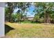 Lush backyard with mature trees offering shade, backing up to a neighboring home at 1850 Martin Luther King, Jr. E Blvd, Bartow, FL 33830