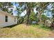 A spacious backyard with healthy grass and mature trees surrounding the property at 1850 Martin Luther King, Jr. E Blvd, Bartow, FL 33830