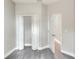 A clean bedroom with an open closet and door, complemented by light grey walls and modern gray wood floors at 1850 Martin Luther King, Jr. E Blvd, Bartow, FL 33830