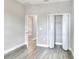 A well-lit bedroom with a closet and an open door, offering a glimpse into the next room, all with clean, neutral tones at 1850 Martin Luther King, Jr. E Blvd, Bartow, FL 33830