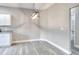 Bright dining area featuring new light gray flooring and modern light fixture at 1850 Martin Luther King, Jr. E Blvd, Bartow, FL 33830