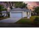 Charming single-story home featuring a two-car garage, neutral paint, and landscaped front yard under a colorful evening sky at 1850 Martin Luther King, Jr. E Blvd, Bartow, FL 33830
