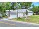 New single-story home featuring a two-car garage, neutral paint, and a grassy front yard on a sunny street at 1850 Martin Luther King, Jr. E Blvd, Bartow, FL 33830