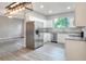 Open kitchen with stainless appliances, granite countertops and light gray flooring at 1850 Martin Luther King, Jr. E Blvd, Bartow, FL 33830