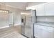 Spacious kitchen with stainless refrigerator, granite countertops and modern lighting at 1850 Martin Luther King, Jr. E Blvd, Bartow, FL 33830