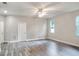 Bright, open-concept living room features wood-look flooring, a modern ceiling fan, and plenty of natural light at 1850 Martin Luther King, Jr. E Blvd, Bartow, FL 33830
