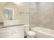 Modern bathroom features a vessel sink, oval mirror, and tiled shower and tub surround at 1890 Martin Luther King, Jr. E Blvd, Bartow, FL 33830