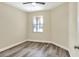 Cozy bedroom with a window allowing for natural light and wood-look flooring at 1890 Martin Luther King, Jr. E Blvd, Bartow, FL 33830