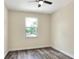 Bedroom featuring wood-look flooring and a window allowing natural light at 1890 Martin Luther King, Jr. E Blvd, Bartow, FL 33830