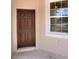 Inviting entryway featuring a new, dark-stained front door with side window, allowing ample natural light at 1890 Martin Luther King, Jr. E Blvd, Bartow, FL 33830