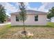 Side view of a newly constructed house with a freshly planted tree in the front yard at 1890 Martin Luther King, Jr. E Blvd, Bartow, FL 33830