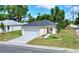 Single-story home boasts a freshly laid lawn, new driveway, and charming facade with a two-car garage at 1890 Martin Luther King, Jr. E Blvd, Bartow, FL 33830