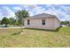 A cozy home sits on a green lawn, complemented by a young tree and clear windows at 1890 Martin Luther King, Jr. E Blvd, Bartow, FL 33830