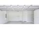 Spacious garage features painted concrete floor and white walls at 1890 Martin Luther King, Jr. E Blvd, Bartow, FL 33830