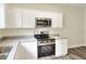 Beautiful kitchen with granite countertops, stainless steel appliances, and white cabinetry for a modern touch at 1890 Martin Luther King, Jr. E Blvd, Bartow, FL 33830