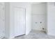 Bright laundry room with white painted walls and concrete flooring at 1890 Martin Luther King, Jr. E Blvd, Bartow, FL 33830