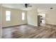 Open-concept living space showcases stylish flooring, large windows, and a view into the modern, white kitchen at 1890 Martin Luther King, Jr. E Blvd, Bartow, FL 33830