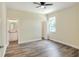 Spacious main bedroom with wood-look flooring, ceiling fan, and ensuite bathroom at 1890 Martin Luther King, Jr. E Blvd, Bartow, FL 33830