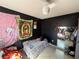 This bedroom features a bed and tapestries on the black wall at 216 Varnadoe Rd, Winter Haven, FL 33880
