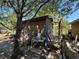 Exterior of a shed under the trees and a utility sink with cinderblocks near what looks to be a deck and other building supplies at 216 Varnadoe Rd, Winter Haven, FL 33880