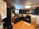 Kitchen featuring laminate floors, cabinets, sink, stove, and window at 216 Varnadoe Rd, Winter Haven, FL 33880