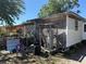 Image displaying the exterior of the back of the house, shed, water heater, and yard at 216 Varnadoe Rd, Winter Haven, FL 33880