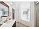 Bathroom with a soaking tub, dark wood vanity with white countertop, and tiled floors at 217 Dillon Way, Davenport, FL 33897