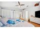 Bright bedroom features a ceiling fan, multiple closets, and a stylish decor at 217 Dillon Way, Davenport, FL 33897