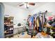 Bedroom with a ceiling fan, sewing machine, rack of shoes, clothes rack, and a desk at 217 Dillon Way, Davenport, FL 33897