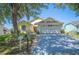Well-maintained single-story home with a two-car garage, mature trees, and landscaped front yard at 217 Dillon Way, Davenport, FL 33897