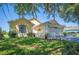 Beautiful one-story home featuring a manicured lawn, garden beds, and attached two-car garage at 217 Dillon Way, Davenport, FL 33897