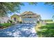 Attractive single-story home with a well-maintained lawn, mature tree, and attached two-car garage at 217 Dillon Way, Davenport, FL 33897