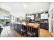 Bright kitchen with butcher block island, modern appliances, a blue accent wall, and an open floor plan at 217 Dillon Way, Davenport, FL 33897