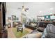 Spacious living room featuring tile floors, a ceiling fan, and an open layout leading to the kitchen at 217 Dillon Way, Davenport, FL 33897