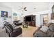 Inviting living room featuring tile floors, a ceiling fan, and a large media center at 217 Dillon Way, Davenport, FL 33897