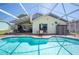 Beautiful backyard pool and lanai with clear blue water and patio seating area at 217 Dillon Way, Davenport, FL 33897