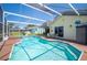 Inviting backyard pool with screened enclosure, patio furniture, and beautifully landscaped surroundings at 217 Dillon Way, Davenport, FL 33897